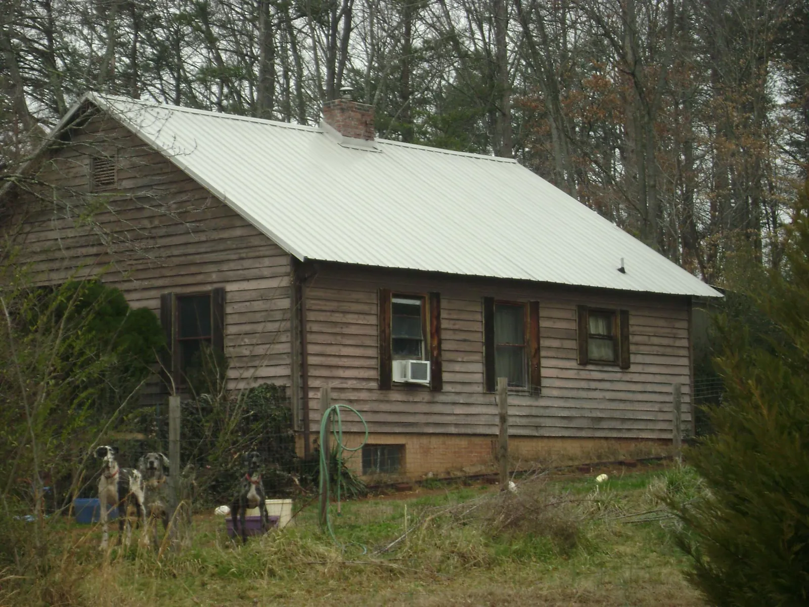 White metal roof on an old wood sided farmhouse, from a Metal Roof Installation job in Nappanee